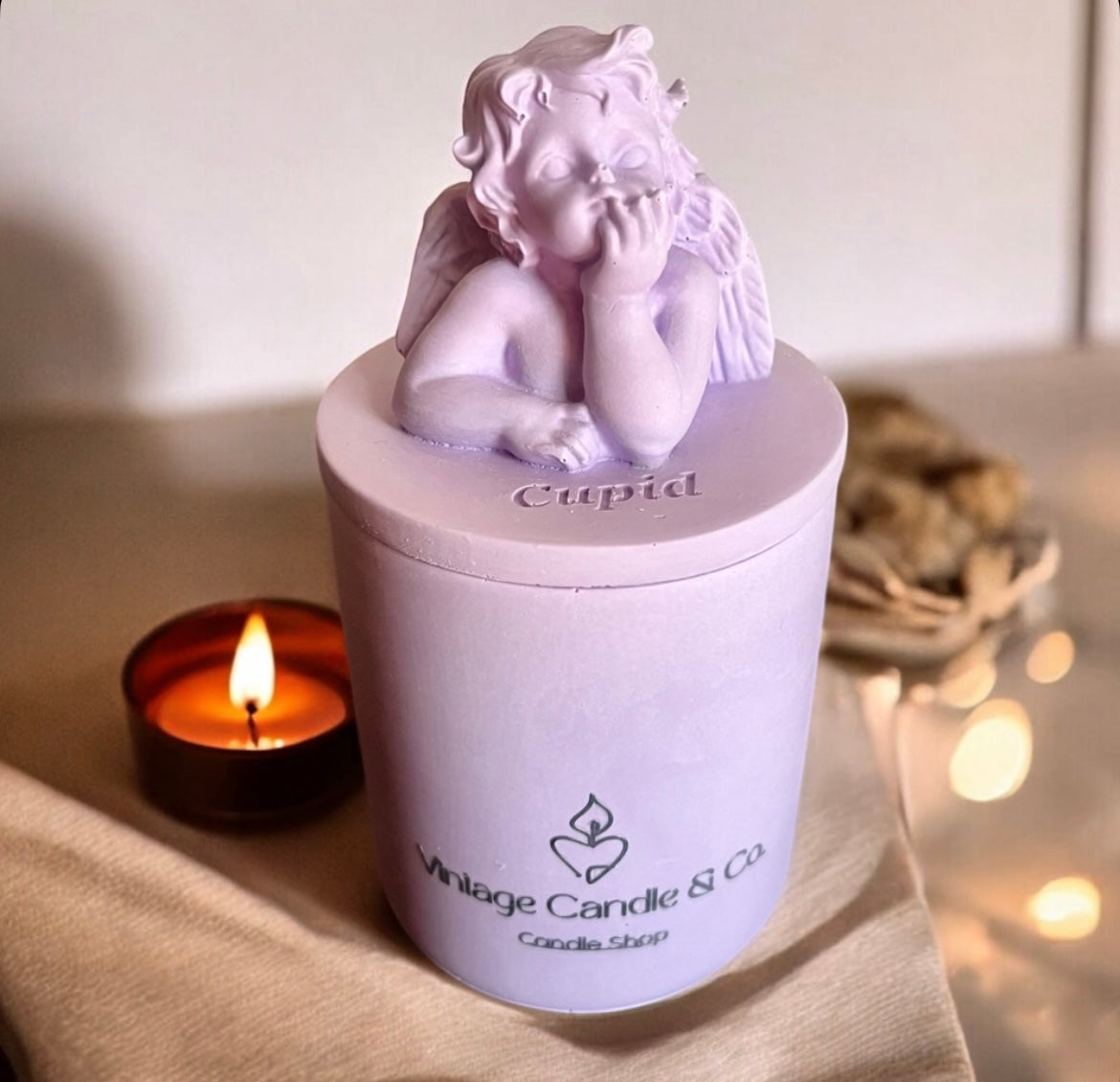 Cupid candle with lid.